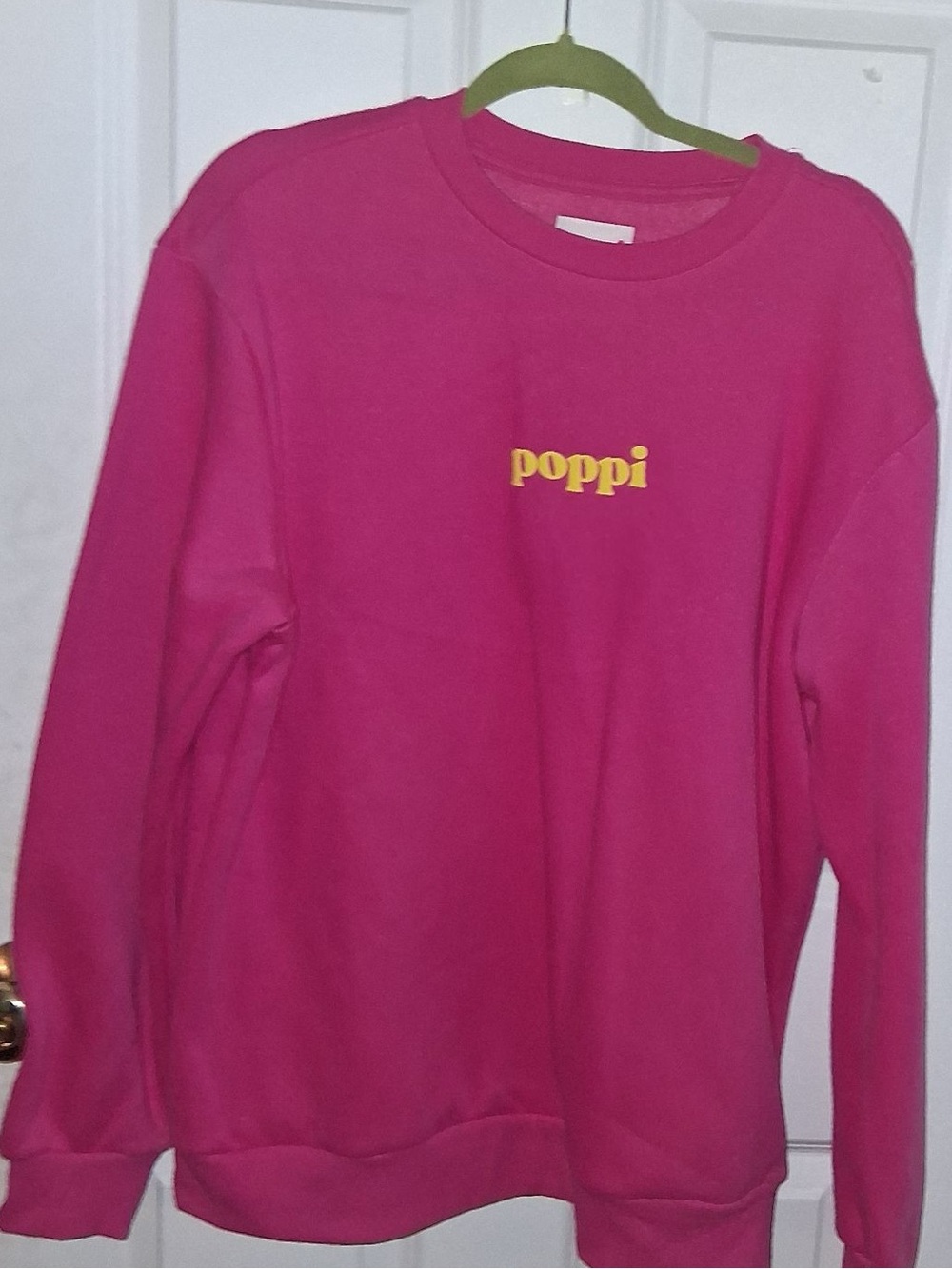 pop bright pink crewneck with yellow poppi logo
